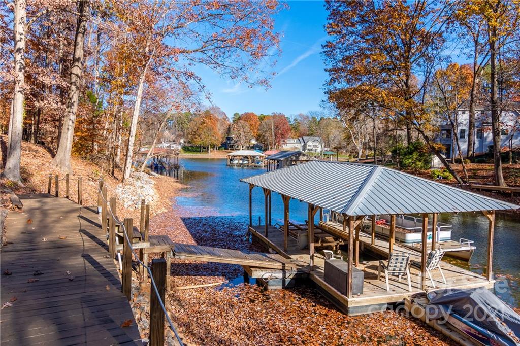 254 Beaten Path Road Mooresville, NC 28117 - Photo 33 of 35 a view of a roof deck with table and chairs under an umbrella