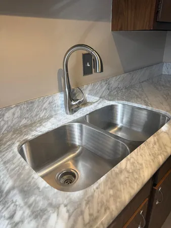 a stove top oven sitting inside of a kitchen