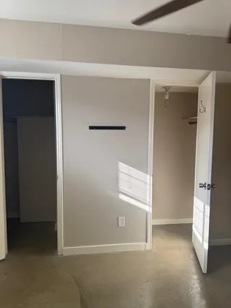 a view of walk in closet with empty racks
