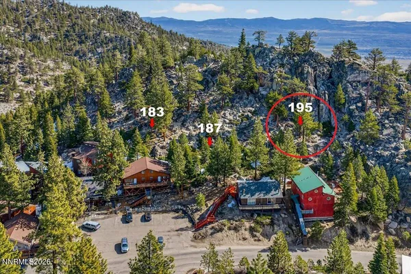 an aerial view of a houses with a street