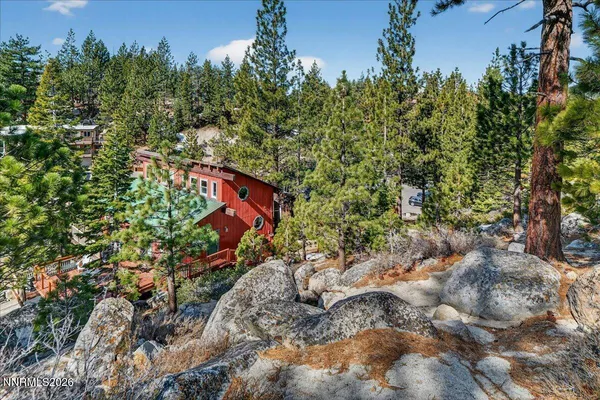 an aerial view of a house with a yard