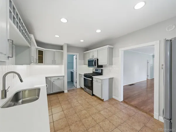 a kitchen with a sink and appliances
