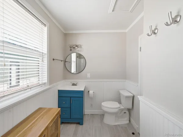a bathroom with a toilet a sink and mirror