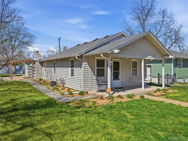 a view of a house with a yard and pathway