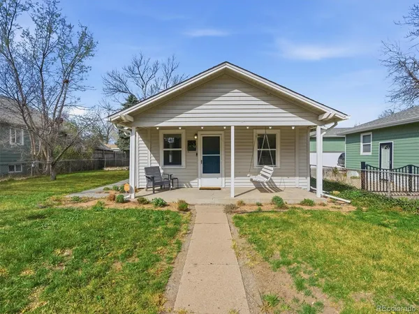 a front view of a house with swimming pool and porch