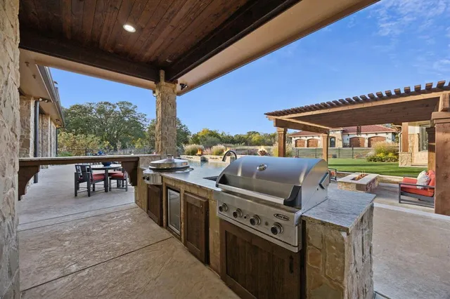 a view of a patio with a dining table and chairs with wooden floor