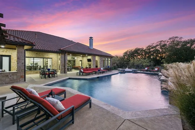 a view of swimming pool with outdoor seating and lake view