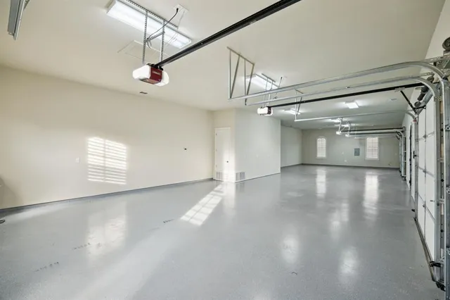 a view of a livingroom with wooden floor a ceiling fan and windows