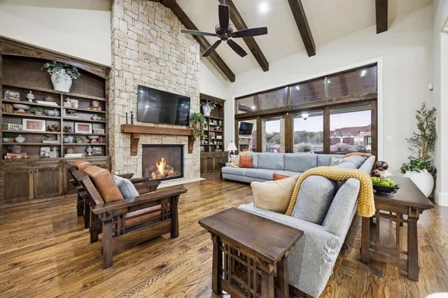 a living room with furniture a flat screen tv and a fireplace