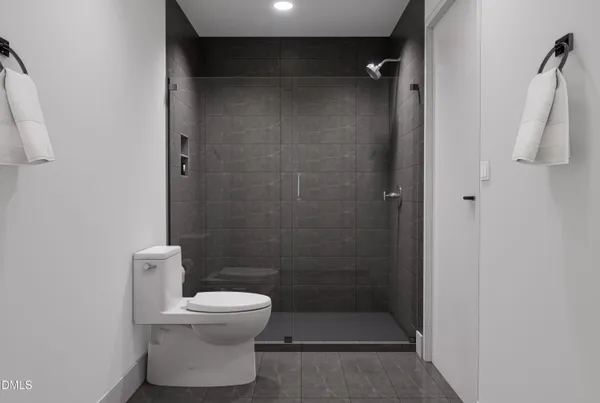 a bathroom with a toilet and a shower