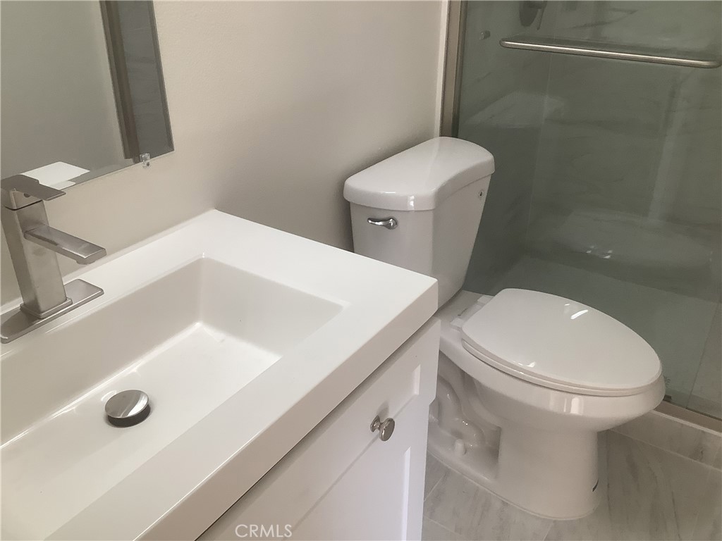 186 Monroe Irvine, CA 92620 - Photo 6 of 12 a white toilet sitting next to a bathroom sink