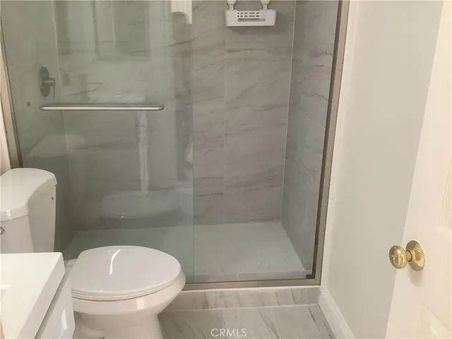 a bathroom with a toilet and a shower