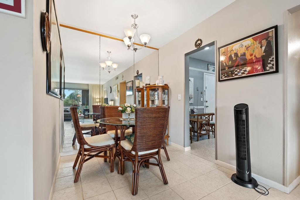400 South Cypress Road, Unit 424 Pompano Beach, FL 33060 - Photo 14 of 40 a dining room with furniture and a chandelier