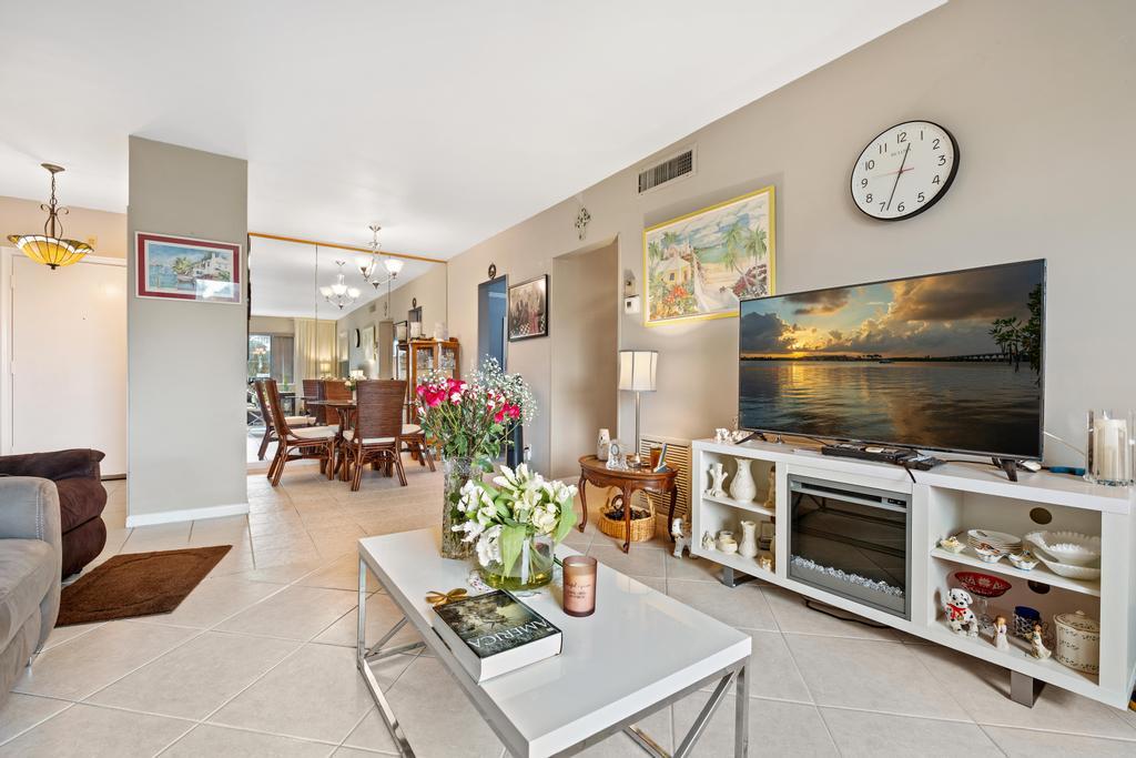 400 South Cypress Road, Unit 424 Pompano Beach, FL 33060 - Photo 3 of 40 a living room with furniture and a flat screen tv