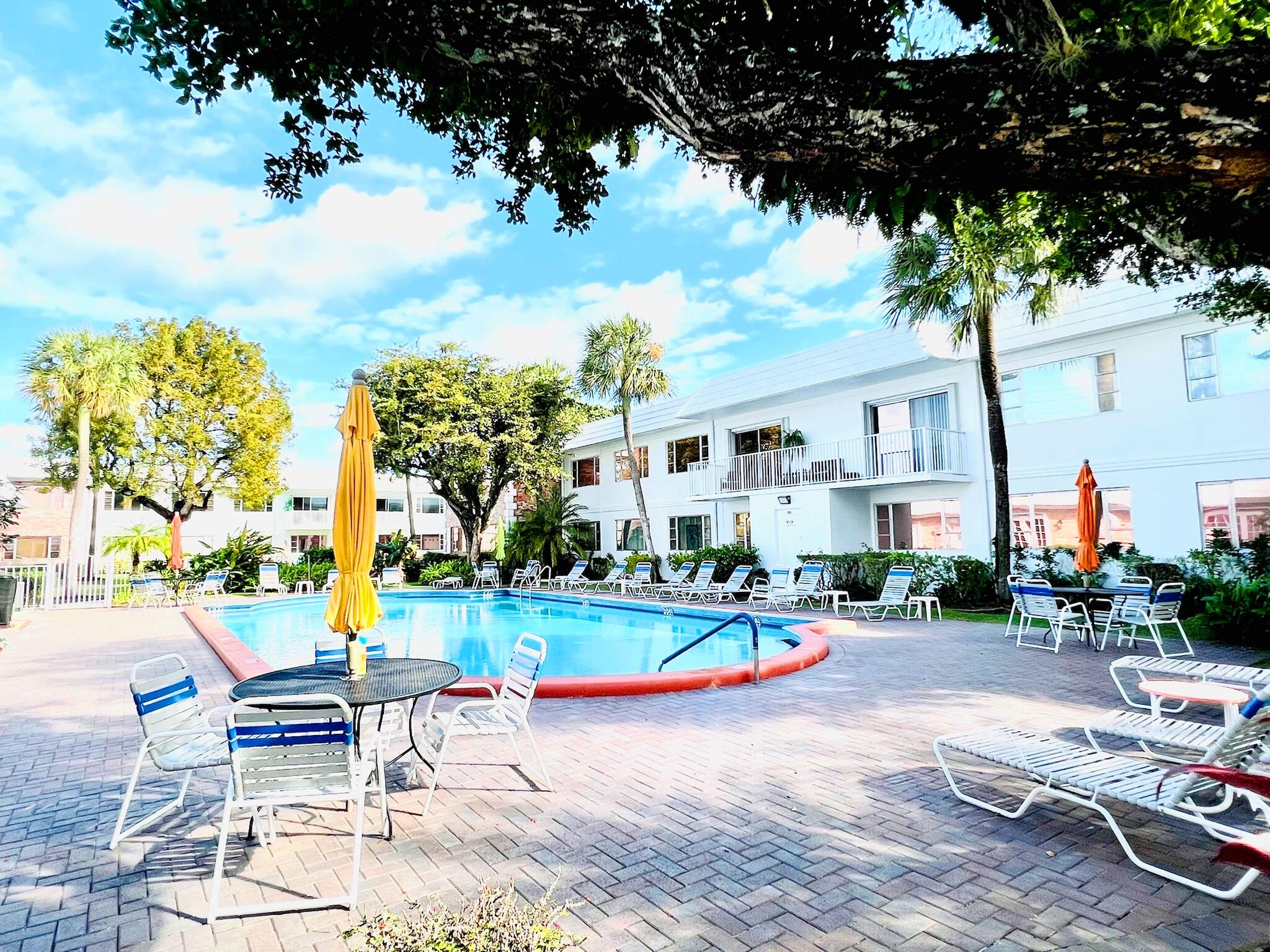 400 South Cypress Road, Unit 424 Pompano Beach, FL 33060 - Photo 35 of 40 a view of pool with lawn chairs and a yard