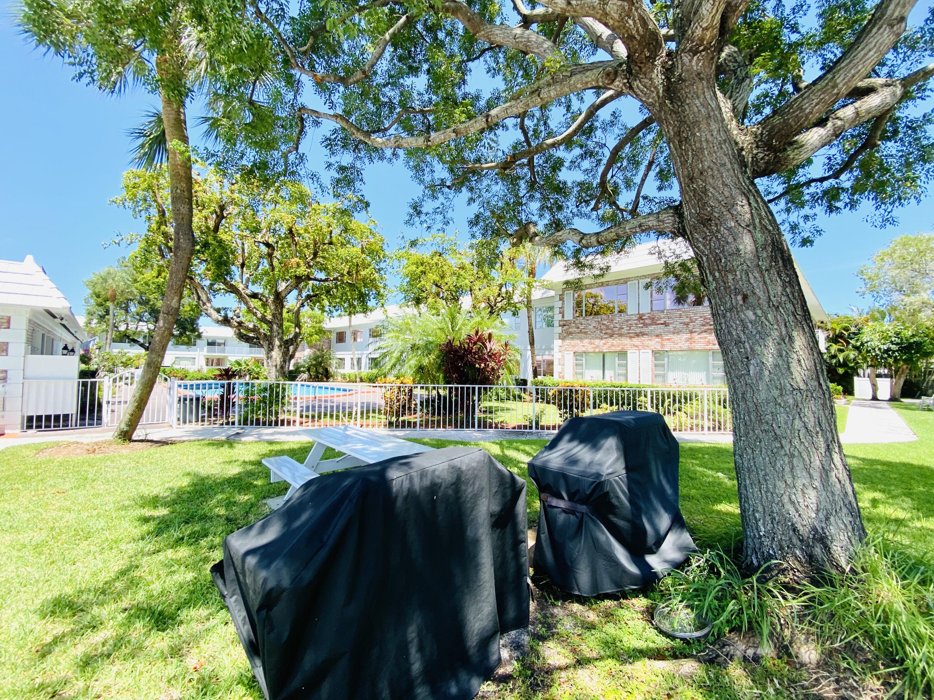 400 South Cypress Road, Unit 424 Pompano Beach, FL 33060 - Photo 36 of 40 a view of yard with seating area and trees around