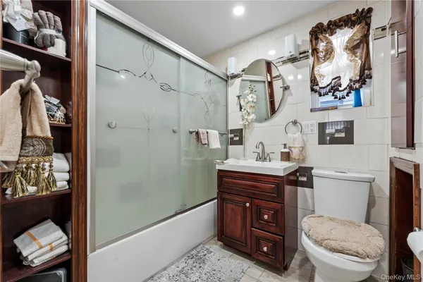 a bathroom with a granite countertop toilet sink and mirror