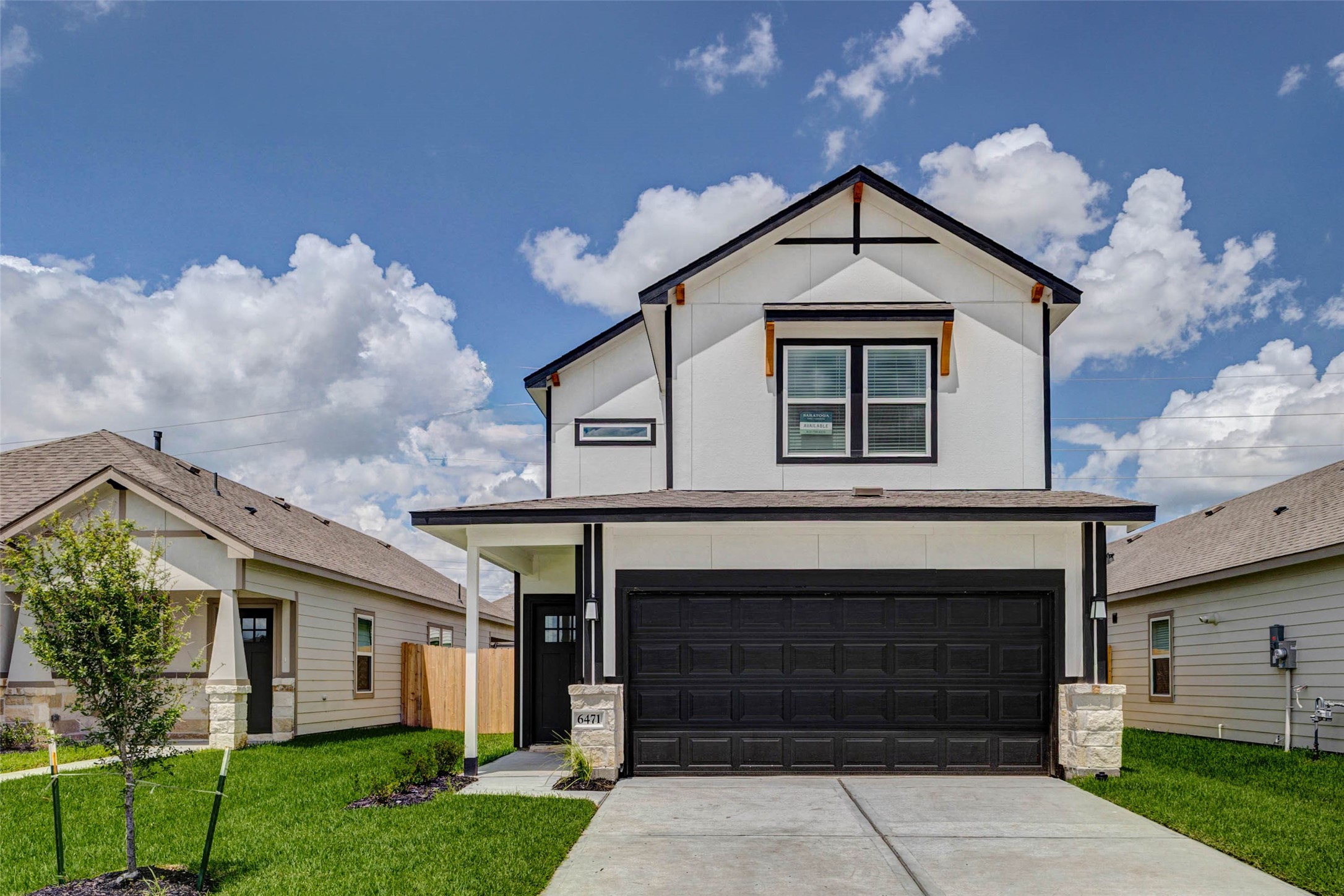 6471 Escondido Drive Rosharon, TX 77583 - Photo 2 of 33 Front exterior view highlighting the home’s symmetrical elevation, covered porch, black-trimmed windows, stone column bases, and attached two-car garage. The fresh landscaping, green lawn, and bright sky backdrop make this new construction home feel clean, welcoming, and move-in ready.