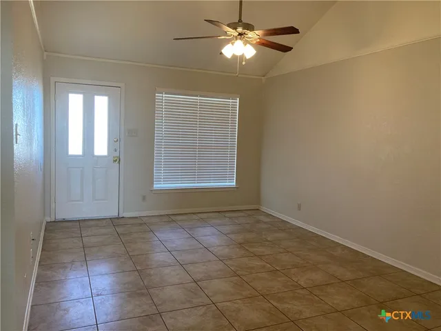 a view of an empty room with a window