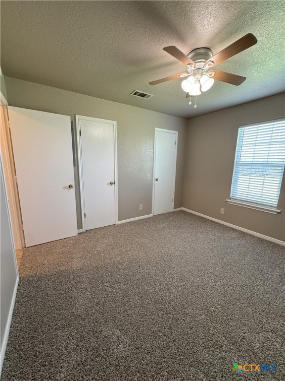 1401 Windward Drive, Unit B Killeen, TX 76543 - Photo 8 of 21 an empty room with windows and chandelier fan
