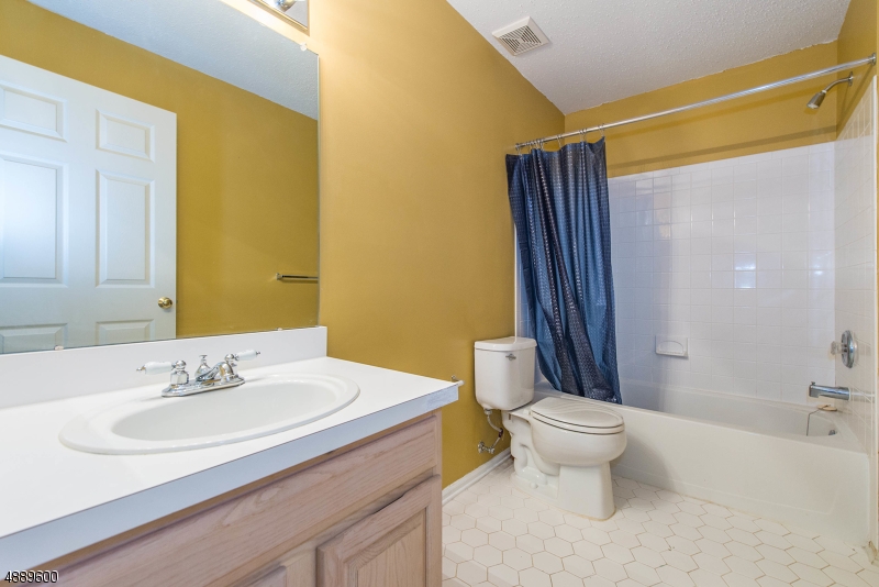 25 Buckingham Court Randolph, NJ 07869 - Photo 19 of 20 a bathroom with a sink and a mirror