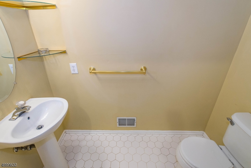 25 Buckingham Court Randolph, NJ 07869 - Photo 20 of 20 a bathroom with a sink a toilet and a mirror