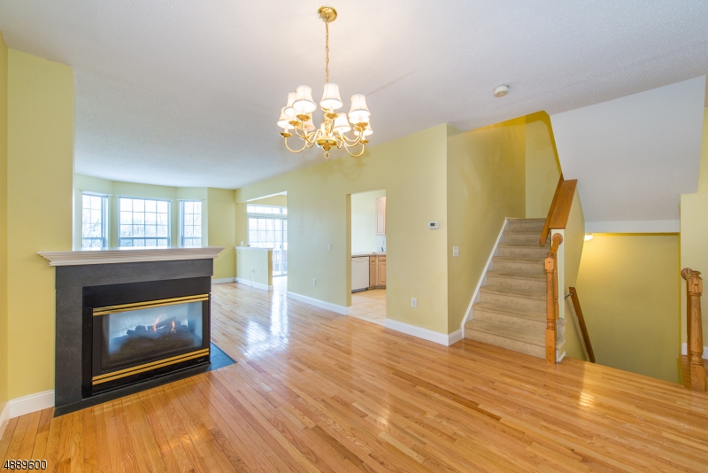 25 Buckingham Court Randolph, NJ 07869 - Photo 5 of 20 a view of a room with wooden floor fireplace and chandelier