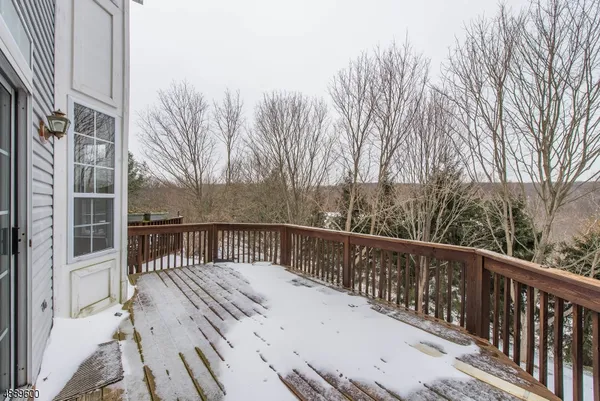a balcony with wooden floor and fence