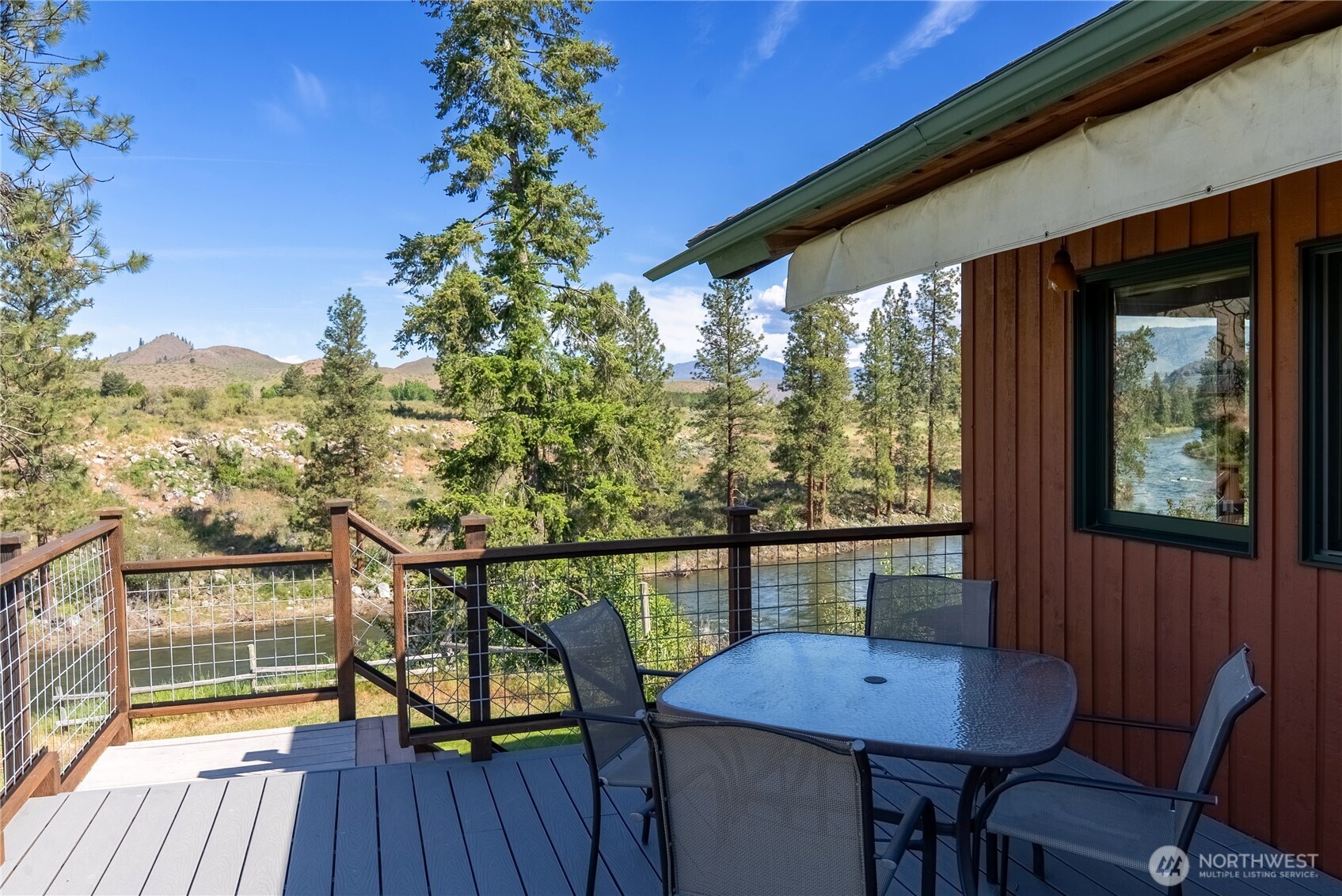 2621 Highway 153 Twisp, WA 98856 - Photo 19 of 40 a view of a chairs and table on the wooden floor