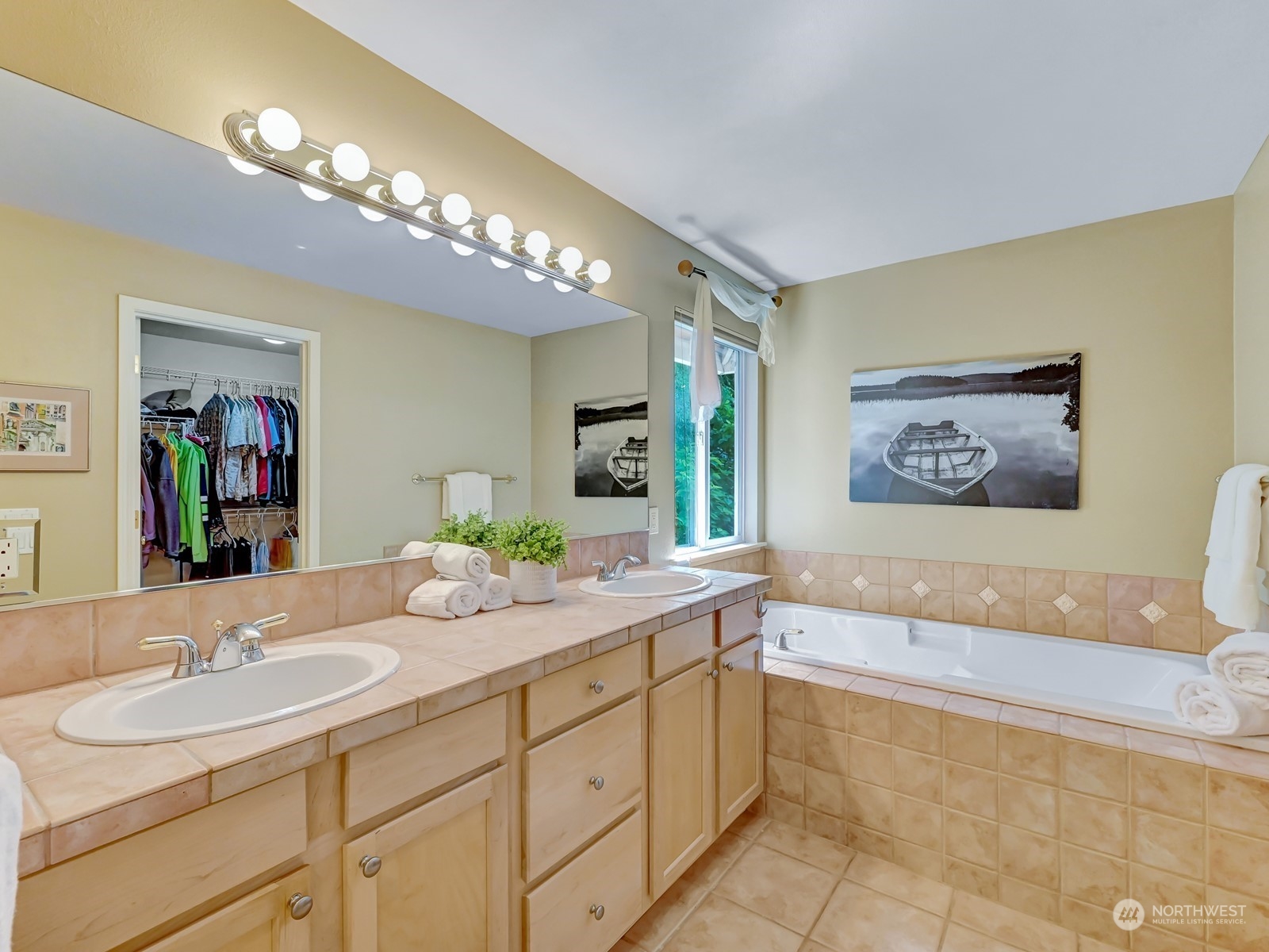 23927 30th Drive Southeast Bothell, WA 98021 - Photo 17 of 32 a spacious bathroom with a sink a large mirror and a bathtub