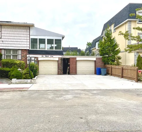 a front view of a house with a yard and a garage