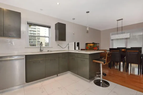 a kitchen with stainless steel appliances kitchen island granite countertop a sink and cabinets
