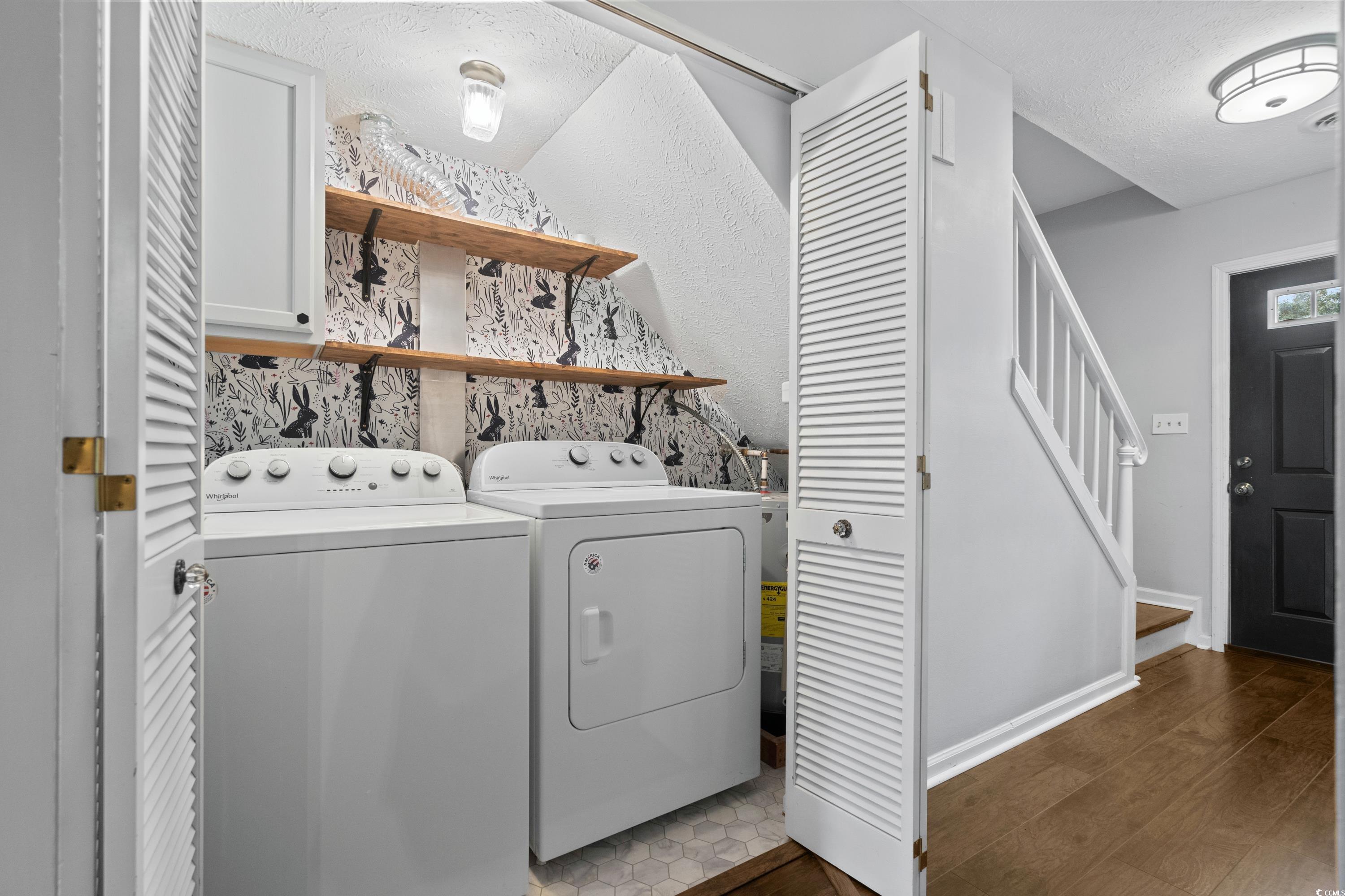 830 44th Avenue North, Unit X5 Myrtle Beach, SC 29577 - Photo 12 of 40 Laundry area featuring dark hardwood / wood-style floors, cabinets, independent washer and dryer, and a textured ceiling
