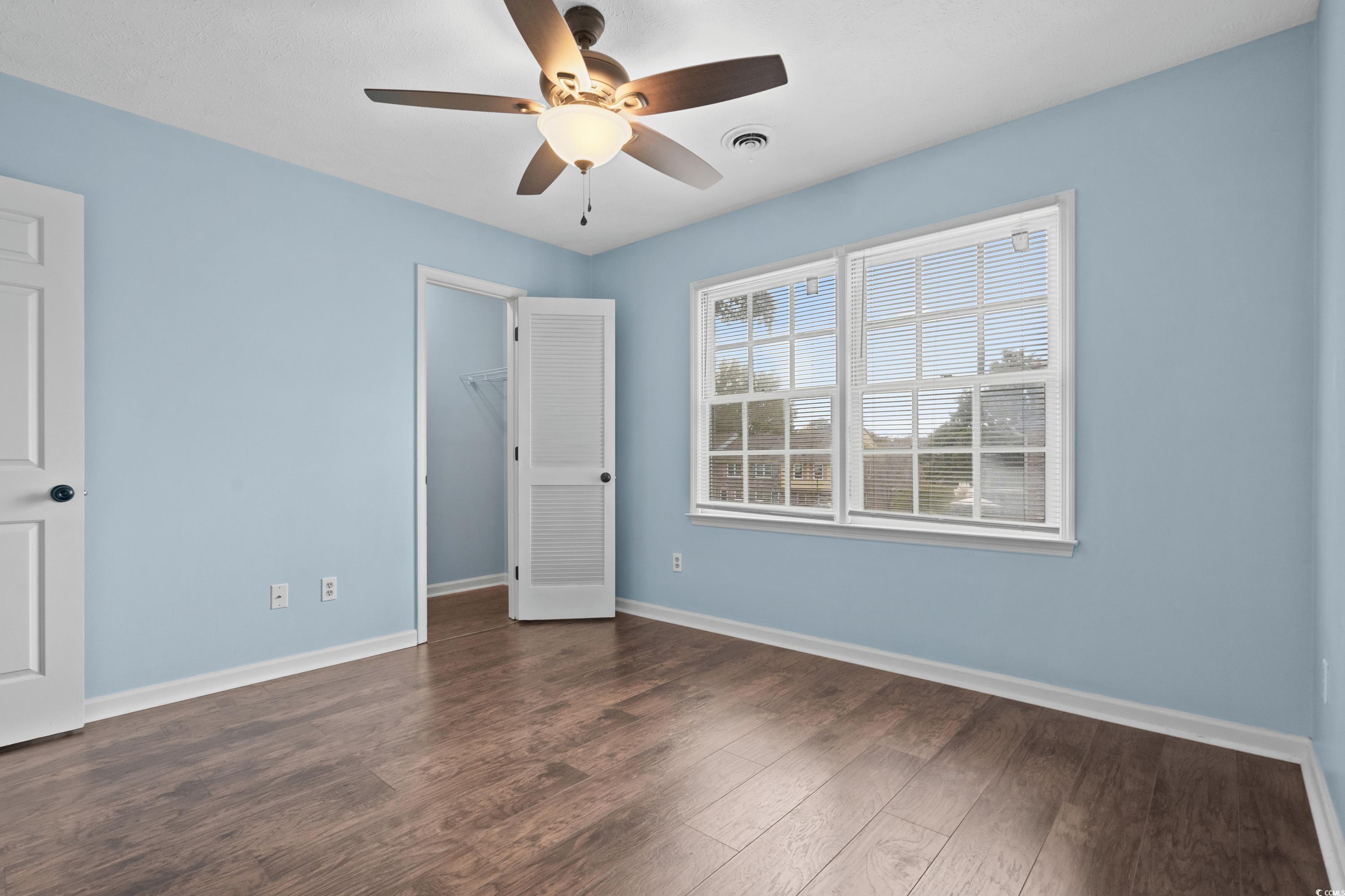 830 44th Avenue North, Unit X5 Myrtle Beach, SC 29577 - Photo 18 of 40 Empty room featuring dark hardwood / wood-style floors and ceiling fan