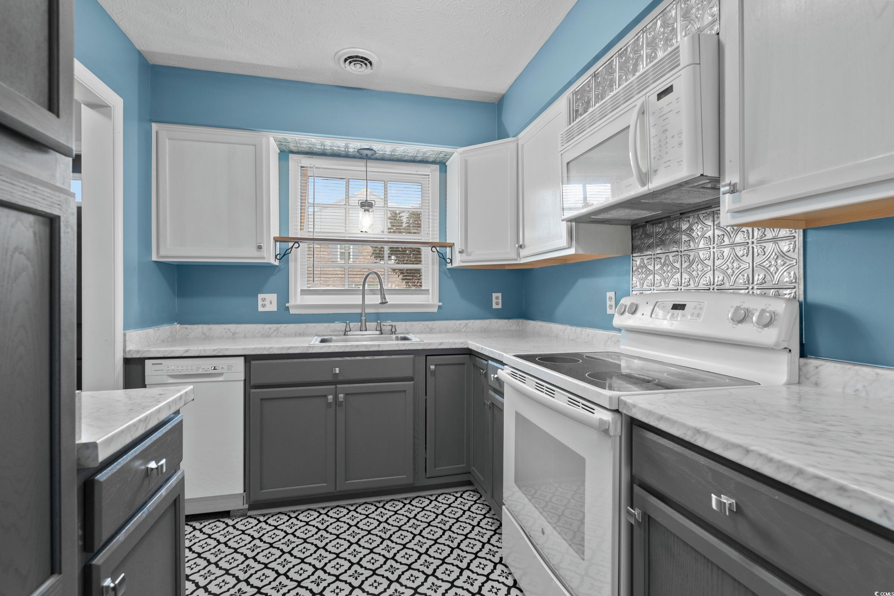 830 44th Avenue North, Unit X5 Myrtle Beach, SC 29577 - Photo 8 of 40 Kitchen featuring white cabinetry, sink, pendant lighting, white appliances, and gray cabinets