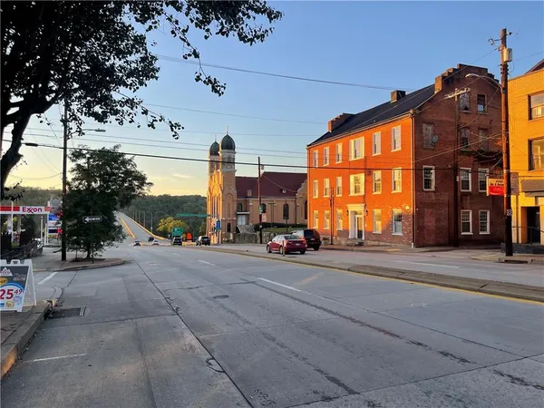 a view of a street with a building in the background