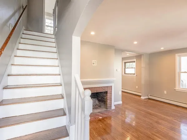 a view of entryway and hall with wooden floor