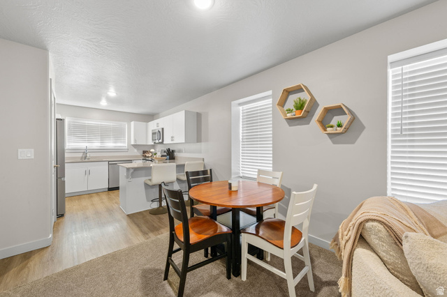 6231 Winding Way, Unit K105 Hurricane, UT 84737 - Photo 6 of 20 Dining area featuring light wood finished floors and a textured ceiling