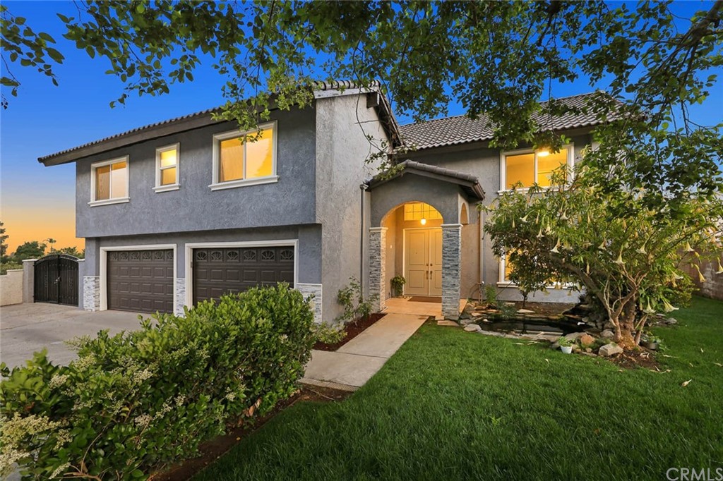9235 Hidden Farm Road Rancho Cucamonga, CA 91737 - Photo 1 of 1 a front view of a house with a yard