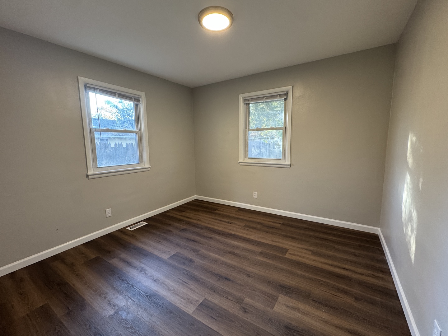 1605 Williamsburg Drive Champaign, IL 61821 - Photo 8 of 11 a view of an empty room with wooden floor and a window