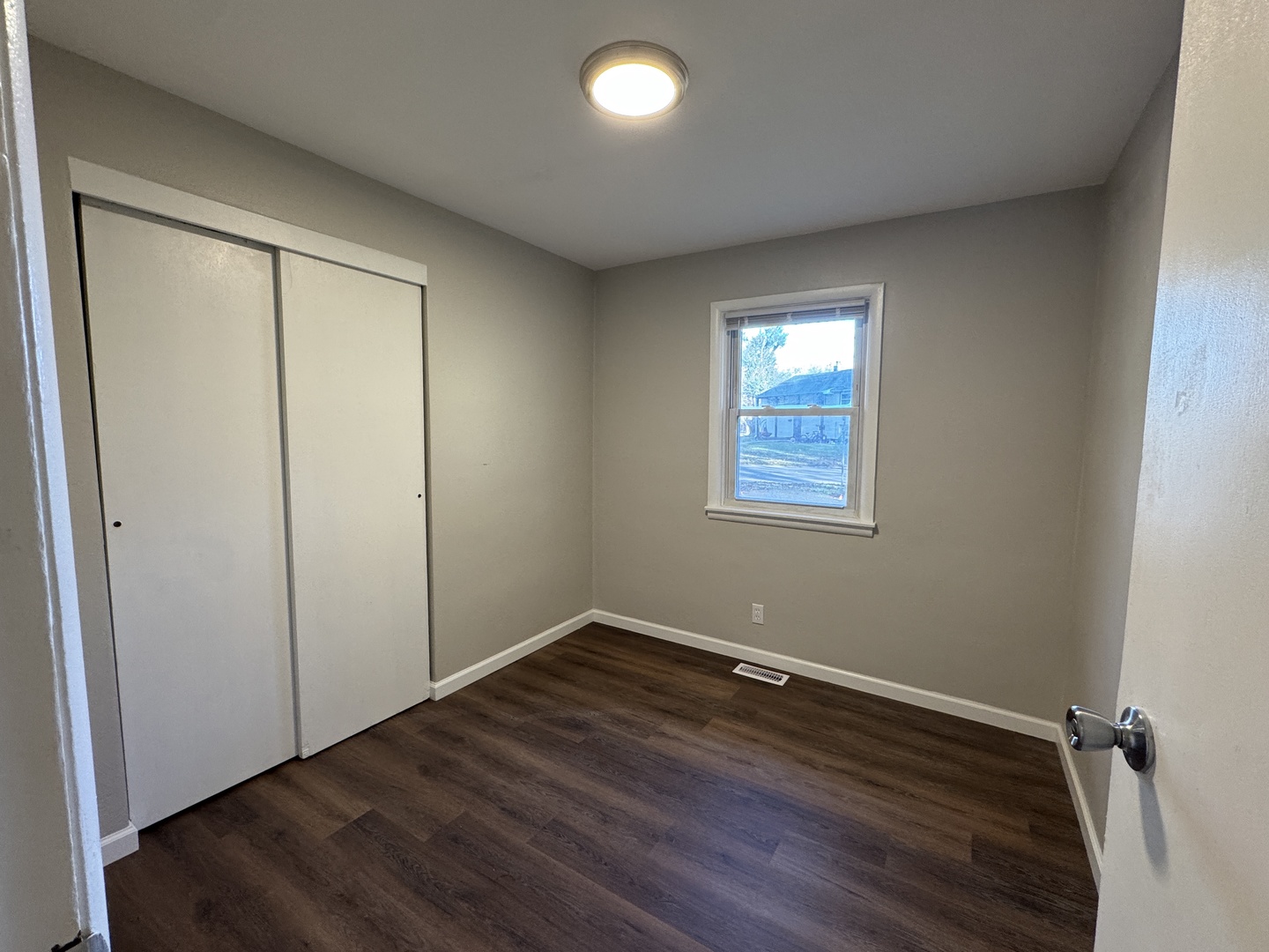 1605 Williamsburg Drive Champaign, IL 61821 - Photo 9 of 11 an empty room with wooden floor and windows
