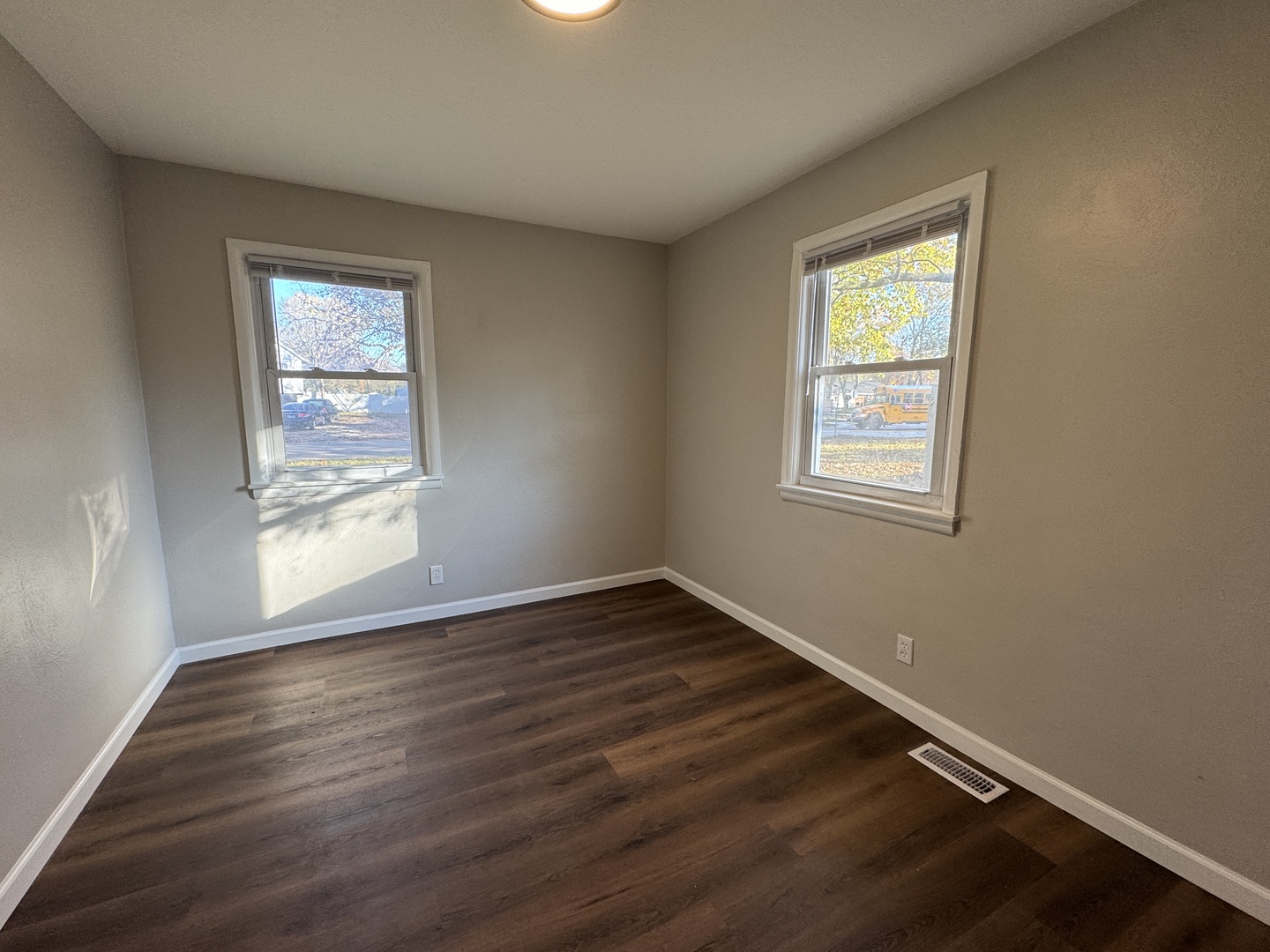 1605 Williamsburg Drive Champaign, IL 61821 - Photo 10 of 11 an empty room with wooden floor and windows