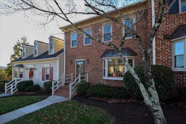 a view of a house with a yard balcony and furniture