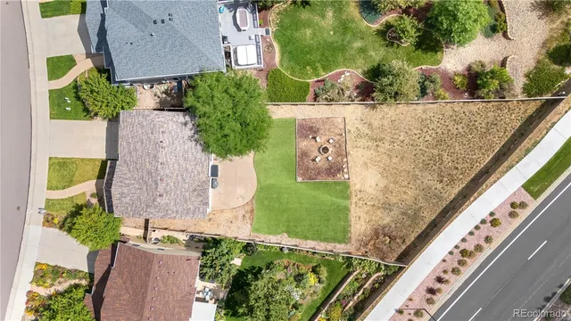 an aerial view of ocean and residential houses with outdoor space