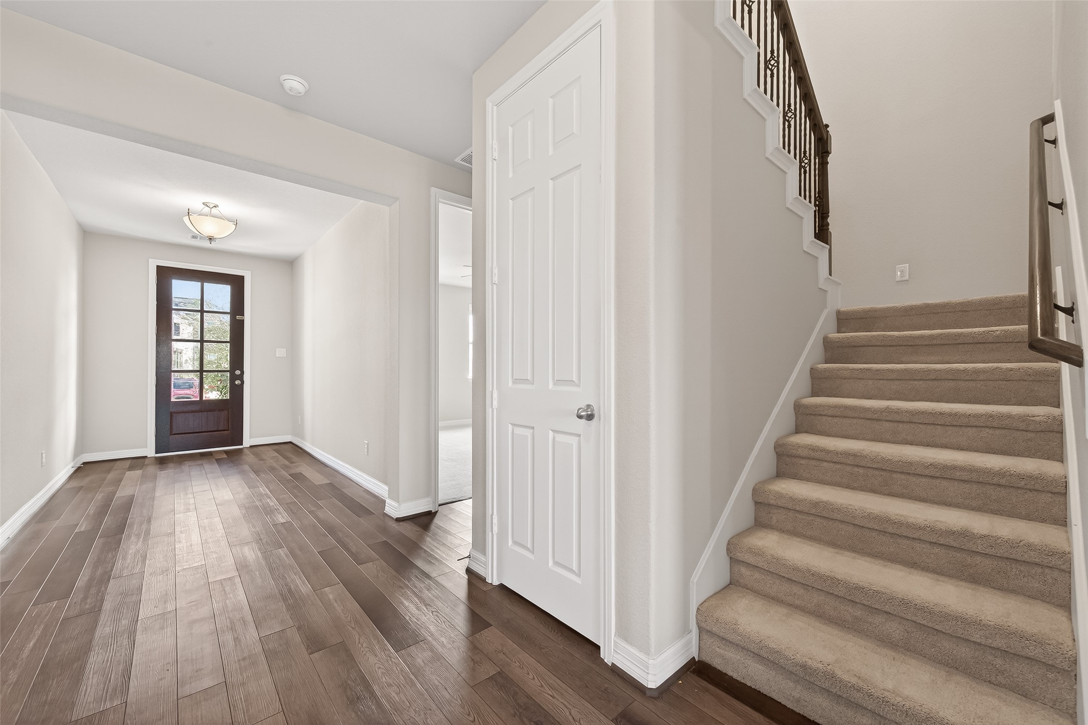 444 Round Lake Drive Rosenberg, TX 77469 - Photo 10 of 50 Beautiful foyer, luxury vinyl wood-look flooring flows throughout the main living areas, while plush, soft carpeting adds comfort on the stairs and in all bedrooms.