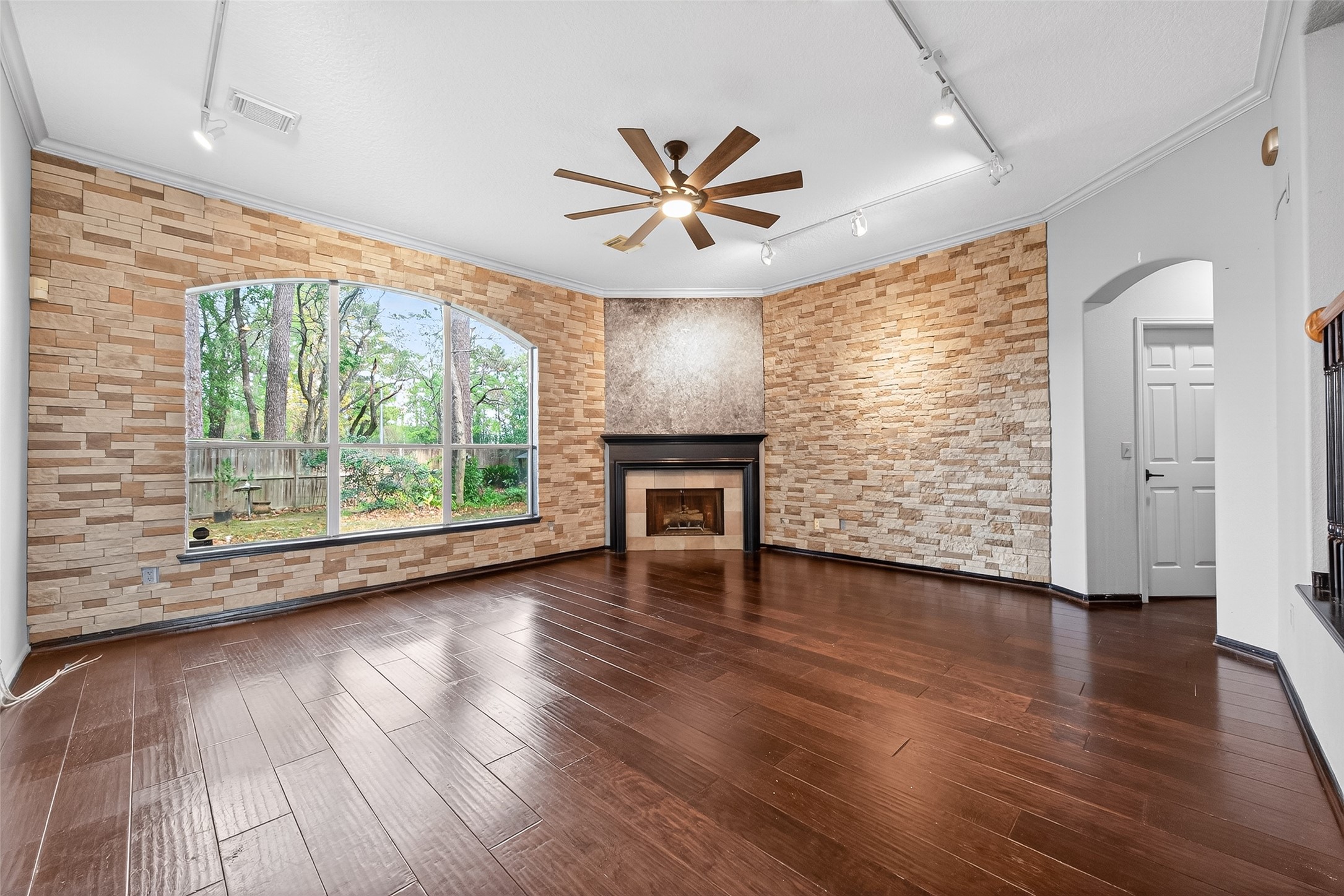 19331 Timber Tree Court Humble, TX 77346 - Photo 16 of 43 an empty room with wooden floor fan and windows