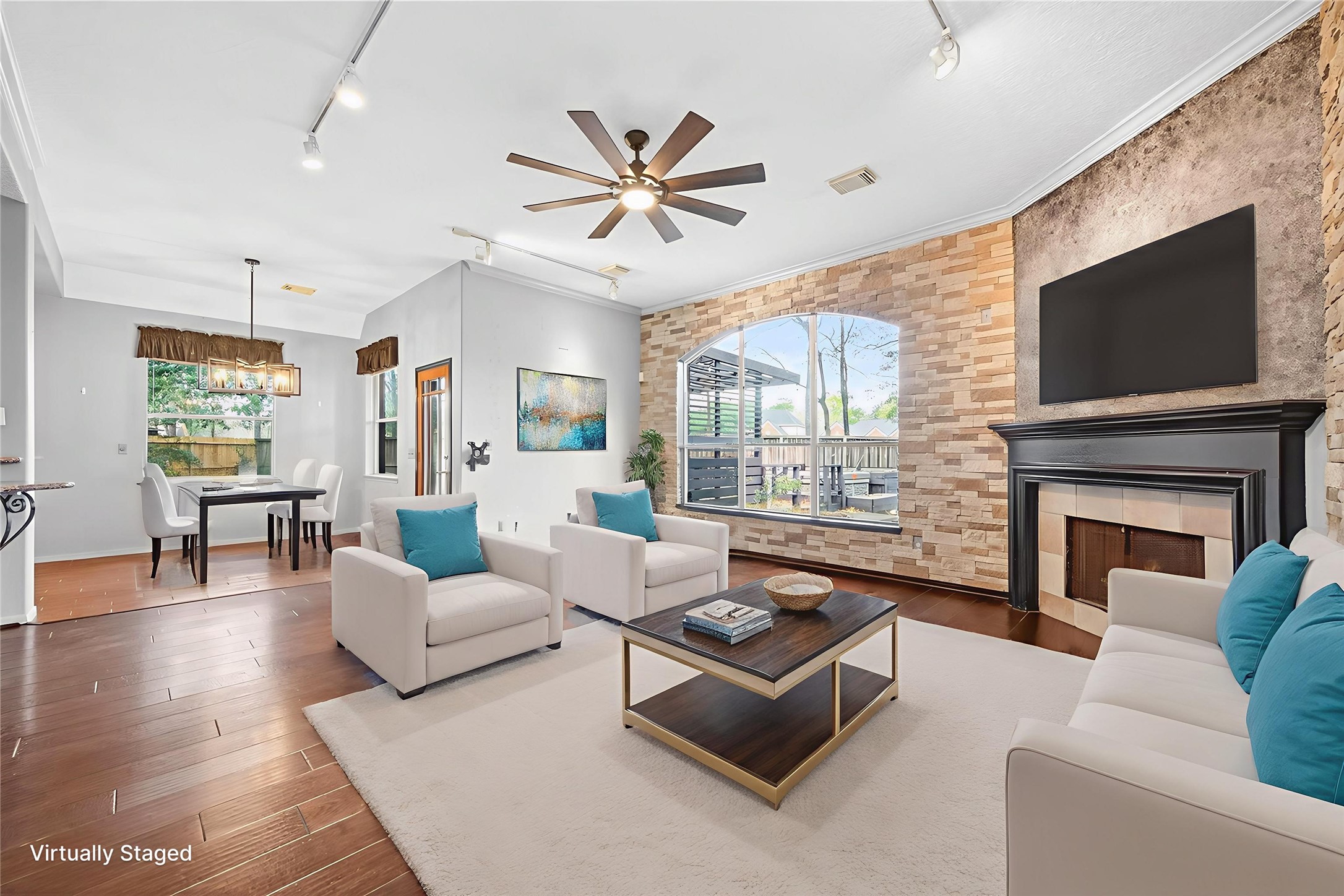 19331 Timber Tree Court Humble, TX 77346 - Photo 2 of 43 a living room with furniture a fireplace and a flat screen tv