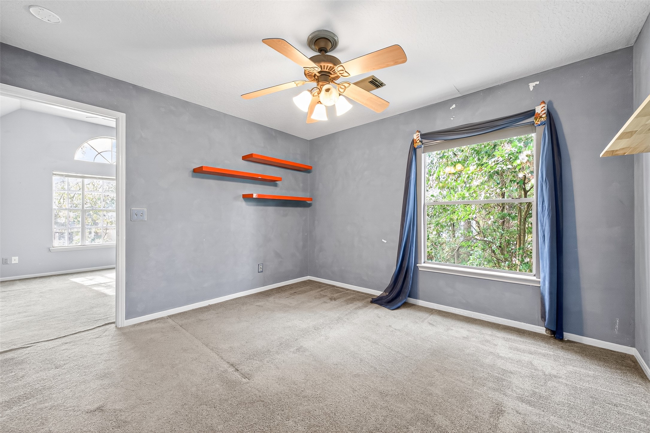 19331 Timber Tree Court Humble, TX 77346 - Photo 31 of 43 an empty room with windows and fan