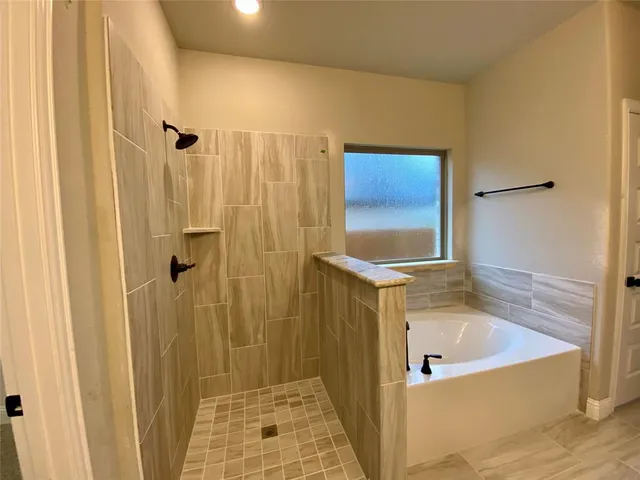 a bathroom with a tub and shower
