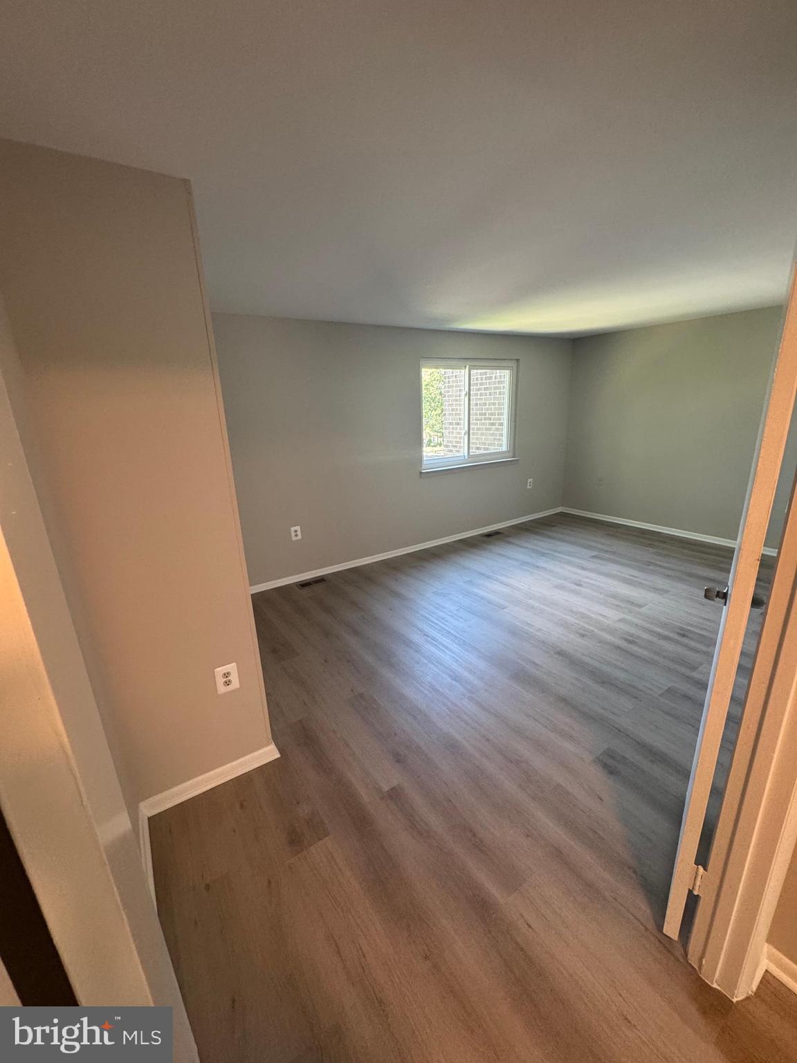 8958 Centerway Road Gaithersburg, MD 20879 - Photo 23 of 37 an empty room with wooden floor and windows